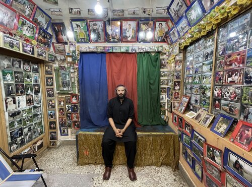 photo of Danial Shah, sitting in a photo studio in Quetta, Pakistan